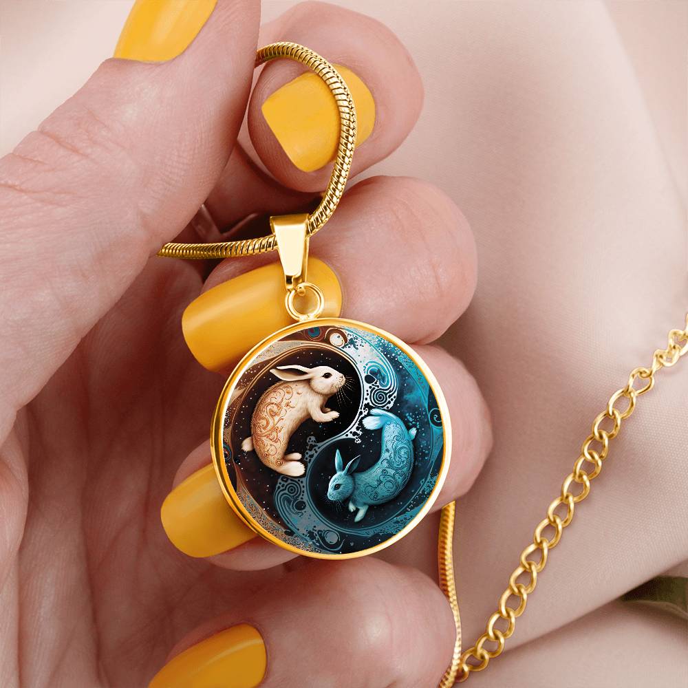 Woman Holding a Gold Pendant Yin Yang Water Rabbit Necklace