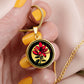 Woman holding an Elegant gold pendant featuring a vivid red honeysuckle, Junes birth month flower, set against a subtle tan backdrop. This necklace offers personalization with an engraving option for a name.