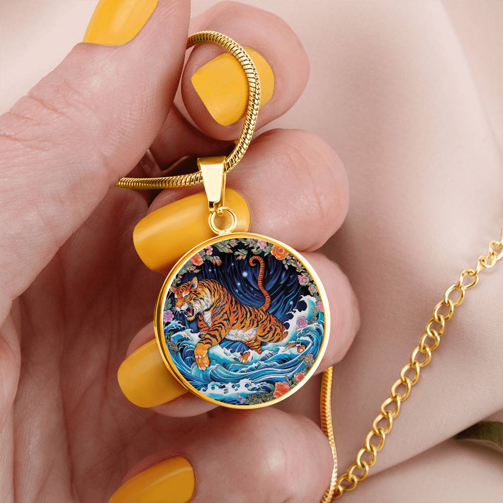 Woman holding an elegant gold pendant Chinese Zodiac Tiger Necklace. The colors are blue, black, green, orange, white, pink, purple and red. This jewelry offers personalization with an engraving option for a name.