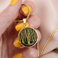 Woman holding An Elegant gold pendant featuring a vivid gold Birch Tree Necklace, set against a Black backdrop. This jewelry offers personalization with an engraving option for a name.