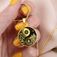 Woman holding An Elegant gold pendant featuring a vivid Gold Fire, Water, snowflakes and Icebergs. set against a Black backdrop. This jewelry offers personalization with an engraving option for a name.