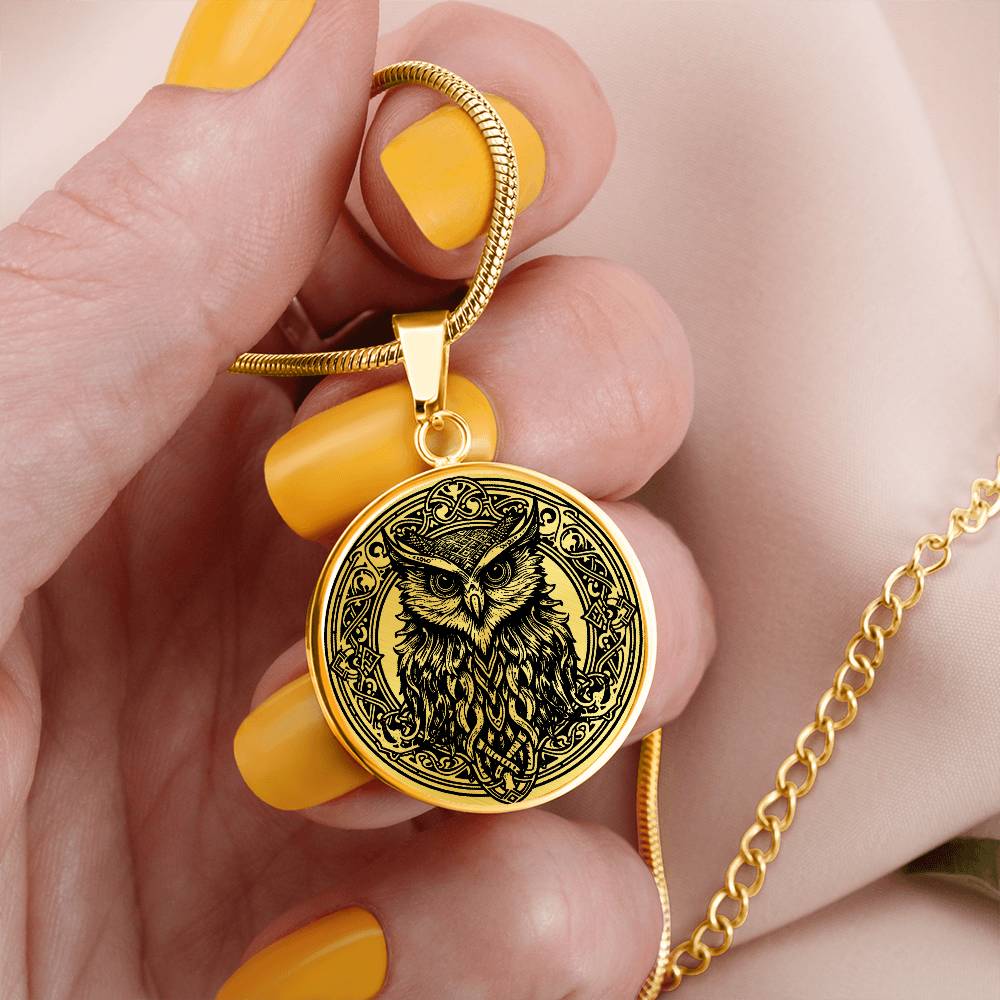 Woman holding an Elegant gold pendant Celtic Owl necklace featuring a vivid Celtic black owl inside a circle frame with a gold backdrop. This jewelry offers personalization with an engraving option for a name.