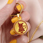 Woman holding a Gold Pig Necklace