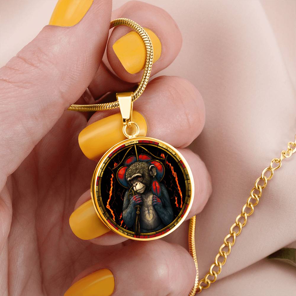 Gold Monkey Necklace in a woman's hand