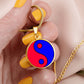 Woman holding a Gold Pendant Fire and Ice Yin Yang Necklace
