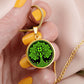 Woman holding an Elegant Gold pendant featuring a vivid Green Celtic four leaf Clover Tree of Life Necklace, set against a Black & gold backdrop. This jewelry offers personalization with an engraving option for a name.