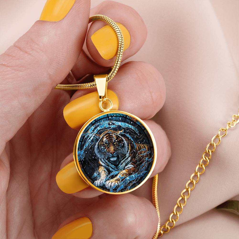 Woman holding an elegant gold pendant Chinese Zodiac Tiger Necklace. The colors are blue, black, orange, white and yellow. This jewelry offers personalization with an engraving option for a name.