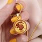Gold Rabbit Necklace in a woman's hand
