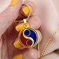 Woman holding an Elegant gold pendant featuring a vivid Fire red & Water blue Celtic Yin Yang Necklace set against a Gold & Black backdrop. This jewelry offers personalization with an engraving option for a name.