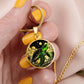 Woman holding an Elegant gold pendant featuring a vivid Green Turtle Necklace with a moon, Stars, Clouds and Ocean set against a black backdrop. This jewelry offers personalization with an engraving option for a name.