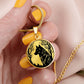 Woman holding an Elegant gold pendant wolf necklace featuring a vivid Black Wolf in the forest, set against a Gold backdrop. This jewelry offers personalization with an engraving option for a name.