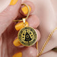 Woman holding an Elegant gold pendant necklace featuring a Winter Christmas theme with a Tree set against a gold backdrop. This necklace offers personalization with an engraving option for a name.
