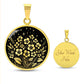 an Elegant gold pendant featuring a vivid African Violet Birth Flower Necklace, set against a subtle gold and Black backdrop. This jewelry offers personalization with an engraving option for a name.