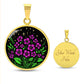 an Elegant gold pendant featuring a vivid Purple African Violet Birth Flower Necklace with green grass, gold stars set against a Black backdrop. This jewelry offers personalization with an engraving option for a name.