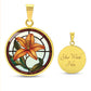 An Elegant Gold pendant necklaces features an Orange Tiger Lily, Green Grass, white background with a red and brown frame. This necklace offers personalization with an engraving option for a name.