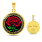 An elegant Celtic gold pendant January Birth Flower Carnation necklace. A vivid red carnation, green stem & leaves, set against a gold & black backdrop. This jewelry offers personalization with an engraving option for a name.