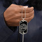 Man holding an elegant Silver pendant Snake and Year of The Dragon Necklace. Colors are silver and black. This jewelry offers personalization with an engraving option for a name.