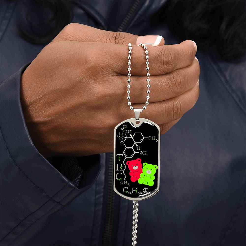 Man holding an elegant silver pendant periodic table THC Bear Necklace. Colors are silver, black, Green and Red. This jewelry offers personalization with an engraving option for a name.