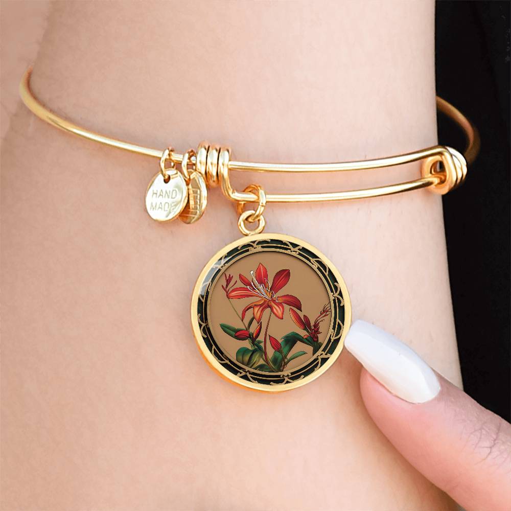 Woman wearing an elegant gold pendant Honeysuckle Bracelet, Junes birth month flower, Colors are Tan, Red, Green and black. This necklace offers personalization with an engraving option for a name.