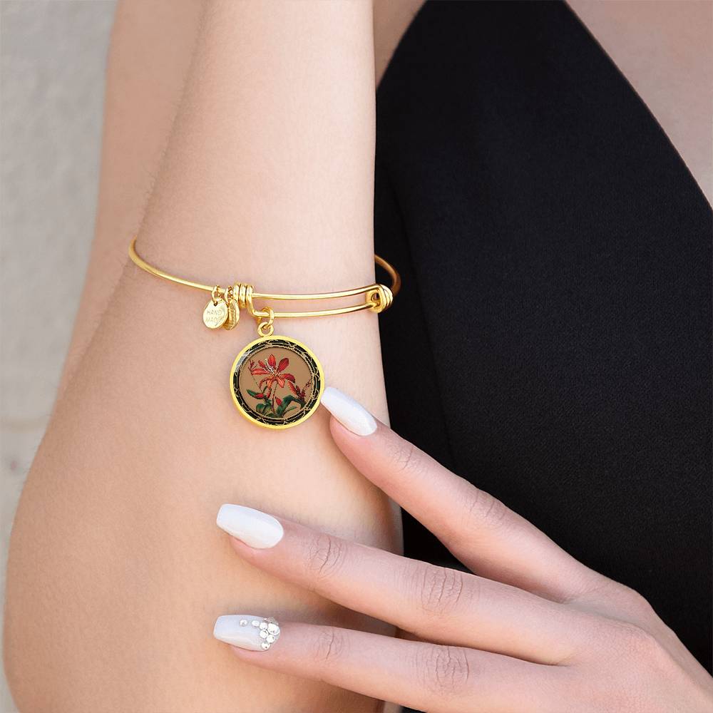 Woman wearing an elegant gold pendant Honeysuckle Bracelet, Junes birth month flower, Colors are Tan, Red, Green and black. This necklace offers personalization with an engraving option for a name.