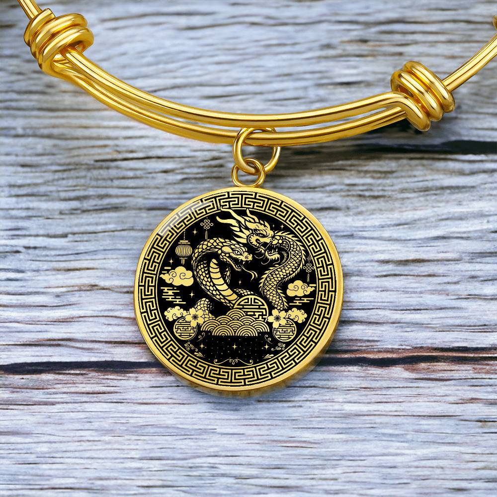 An Elegant gold Year of the Dragon and Snake Bracelet. The colors are gold and black. This bangle bracelet & pendant has an engraving option for a personalization.