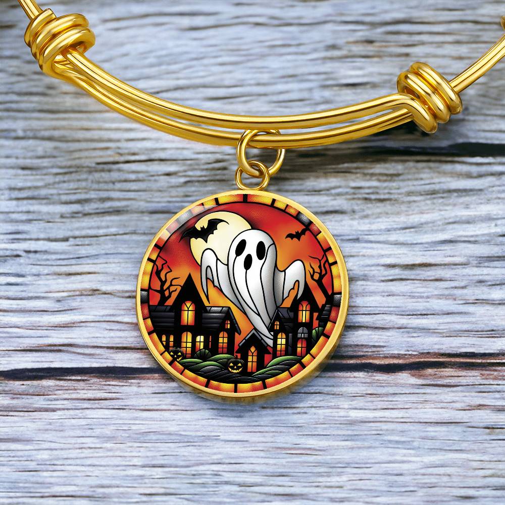 An elegant gold pendant Halloween Ghost Bracelet. The colors are white, black, yellow, orange and green. This jewelry offers personalization with an engraving option for a name.