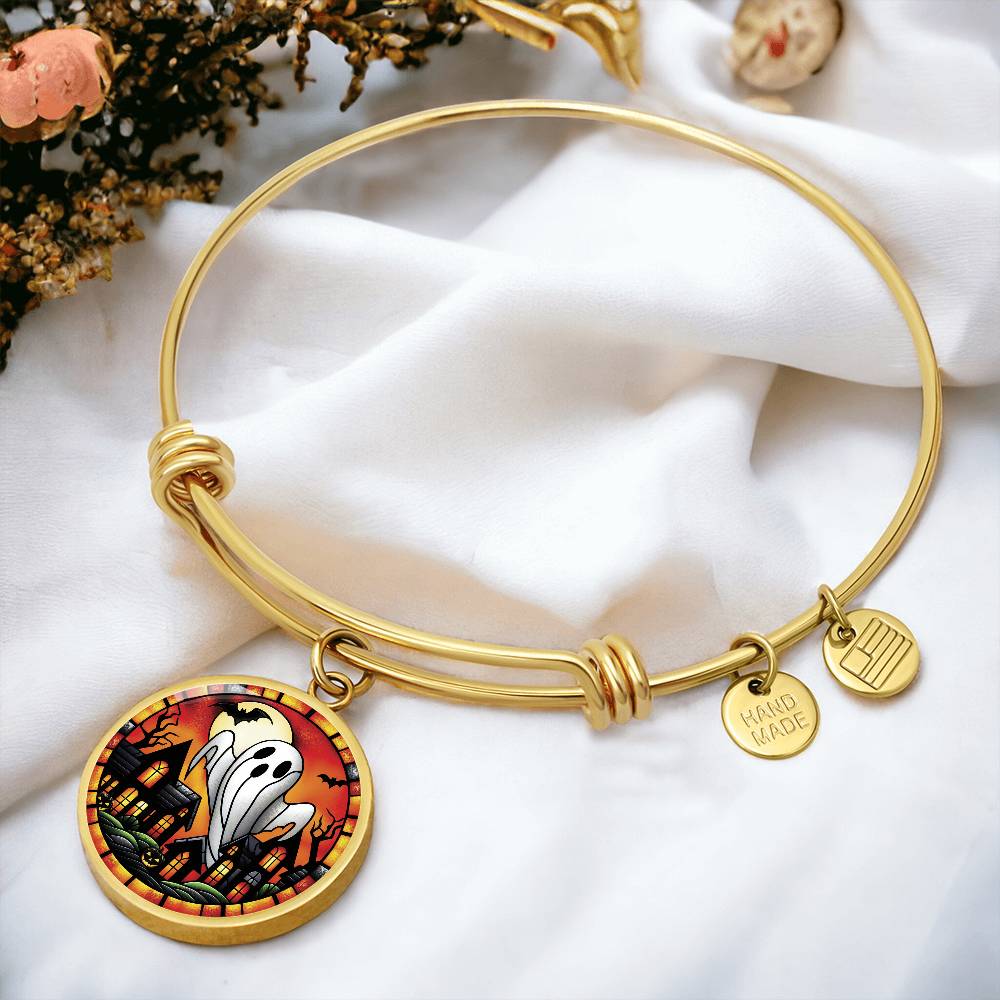 An elegant gold pendant Halloween Ghost Bracelet. The colors are white, black, yellow, orange and green. This jewelry offers personalization with an engraving option for a name.