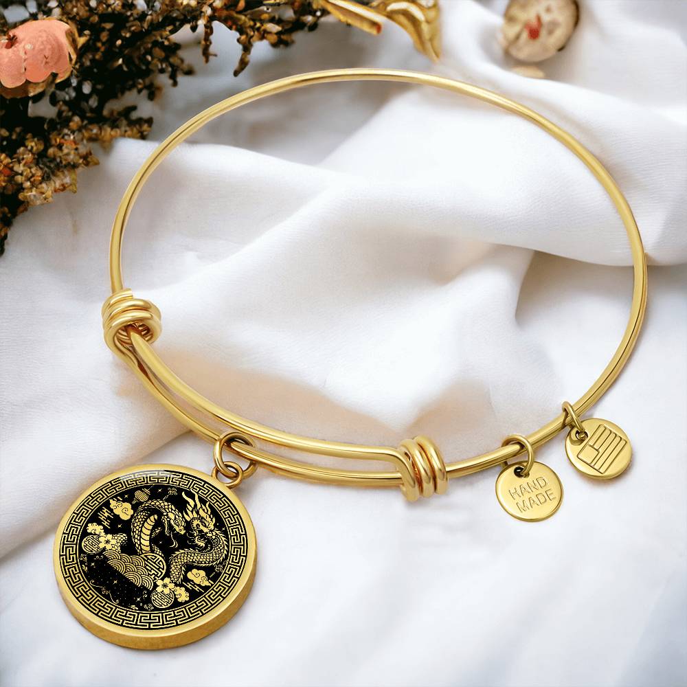 An Elegant gold Year of the Dragon and Snake Bracelet. The colors are gold and black. This bangle bracelet & pendant has an engraving option for a personalization.