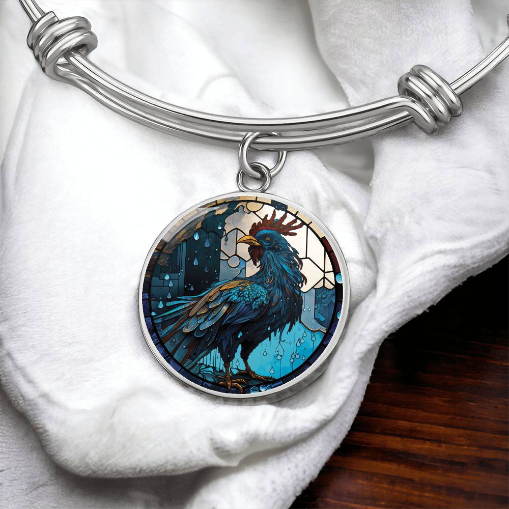 an Elegant silver pendant Rooster Bracelet, featuring a blue/red colored rooster set against a tan/blue Rain backdrop. This jewelry offers personalization with an engraving option for a name.