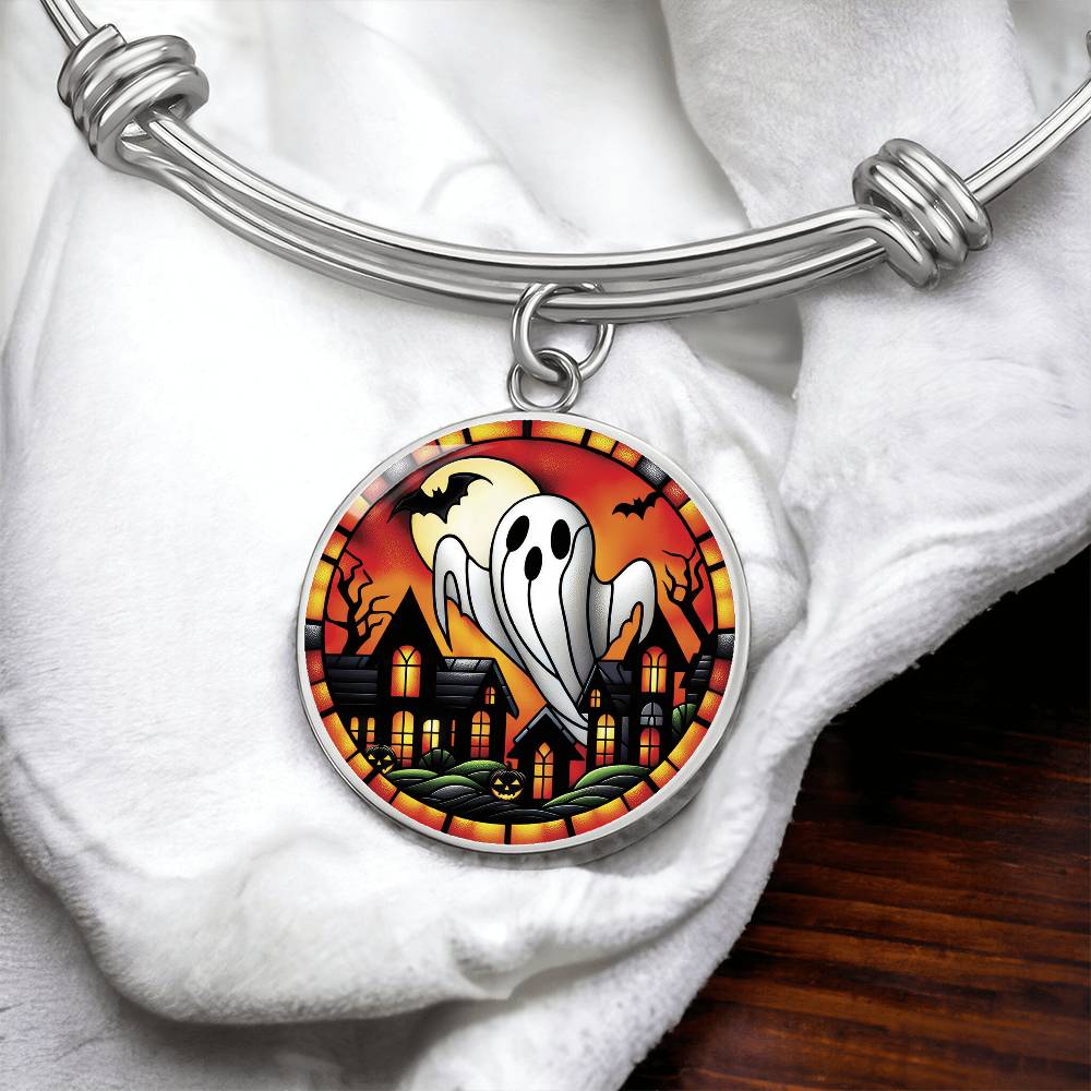 An elegant silver pendant Halloween Ghost Bracelet. The colors are white, black, yellow, orange and green. This jewelry offers personalization with an engraving option for a name.