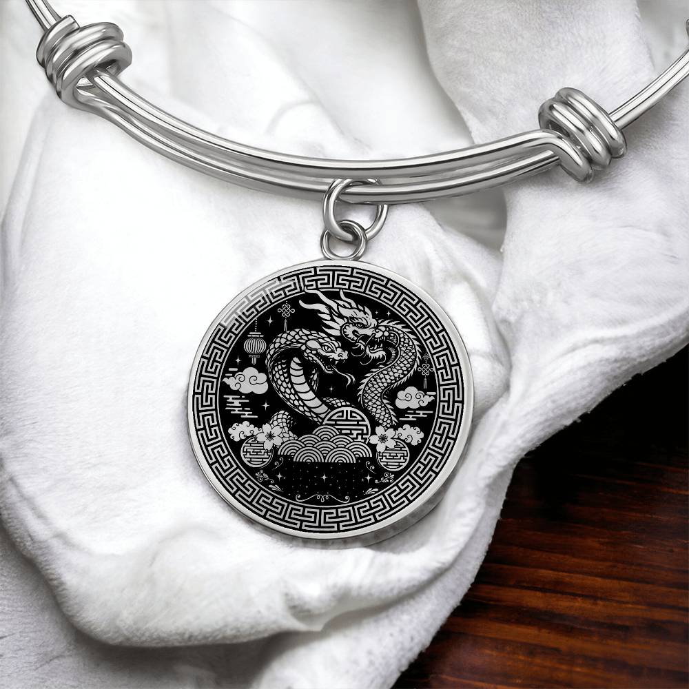 An Elegant silver Year of the Dragon and Snake Bracelet. The colors are silver and black. This bangle bracelet & pendant has an engraving option for a personalization.