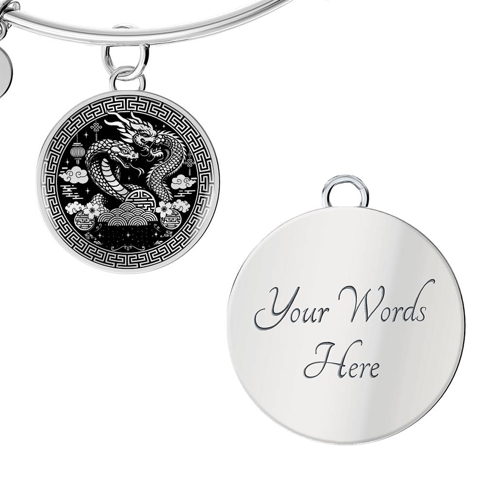 An Elegant silver Year of the Dragon and Snake Bracelet. The colors are silver and black. This bangle bracelet & pendant has an engraving option for a personalization.