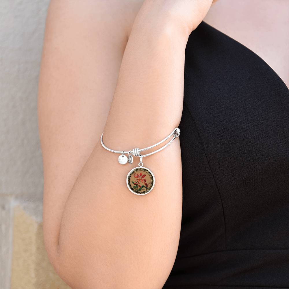 Woman wearing an elegant silver pendant Honeysuckle Bracelet, Junes birth month flower, Colors are Tan, Red, Green and black. This necklace offers personalization with an engraving option for a name.