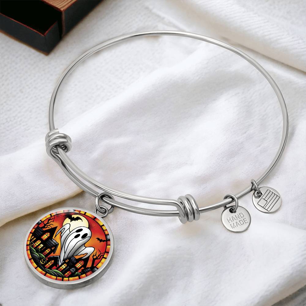 An elegant silver pendant Halloween Ghost Bracelet. The colors are white, black, yellow, orange and green. This jewelry offers personalization with an engraving option for a name.