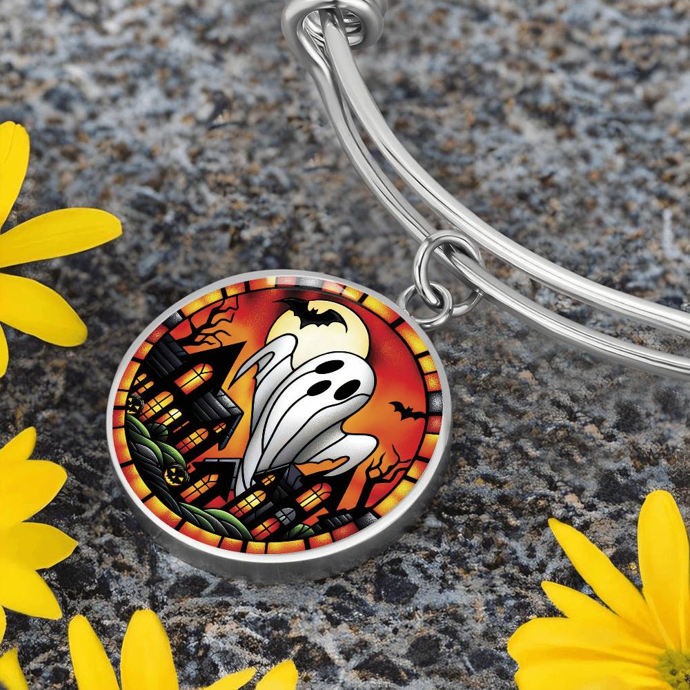 An elegant silver pendant Halloween Ghost Bracelet. The colors are white, black, yellow, orange and green. This jewelry offers personalization with an engraving option for a name.