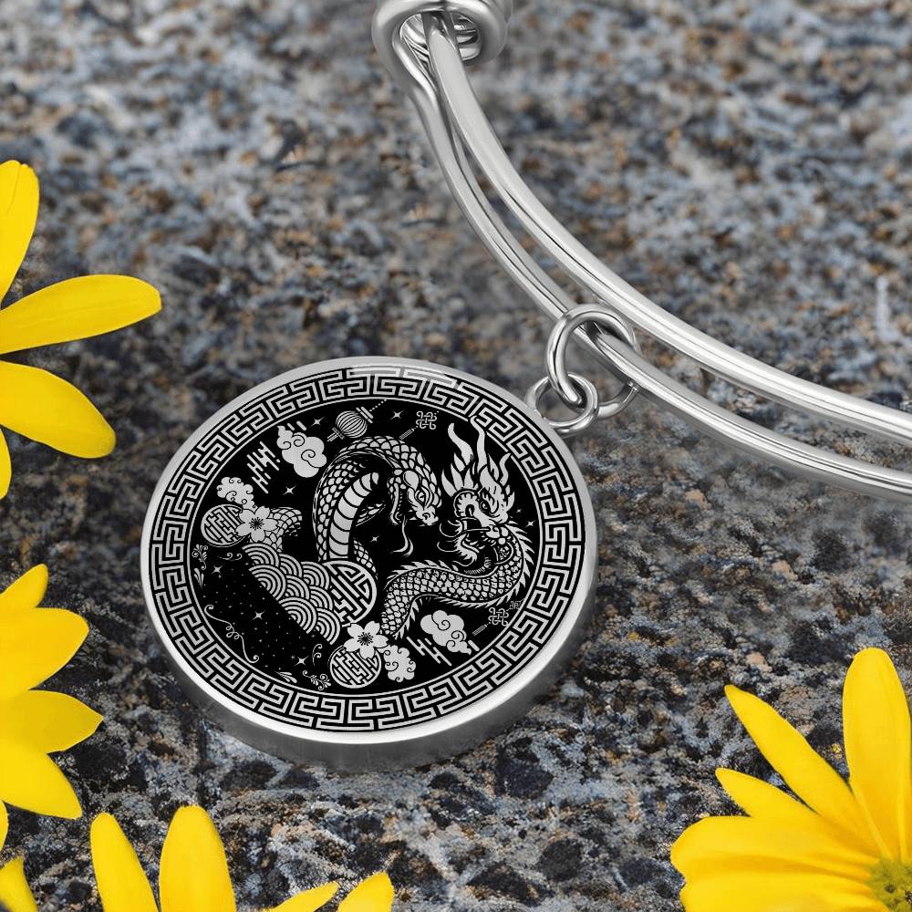 An Elegant silver Year of the Dragon and Snake Bracelet. The colors are silver and black. This bangle bracelet & pendant has an engraving option for a personalization.