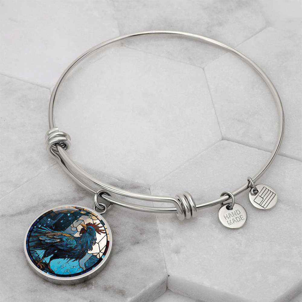 an Elegant silver pendant Rooster Bracelet, featuring a blue/red colored rooster set against a tan/blue Rain backdrop. This jewelry offers personalization with an engraving option for a name.