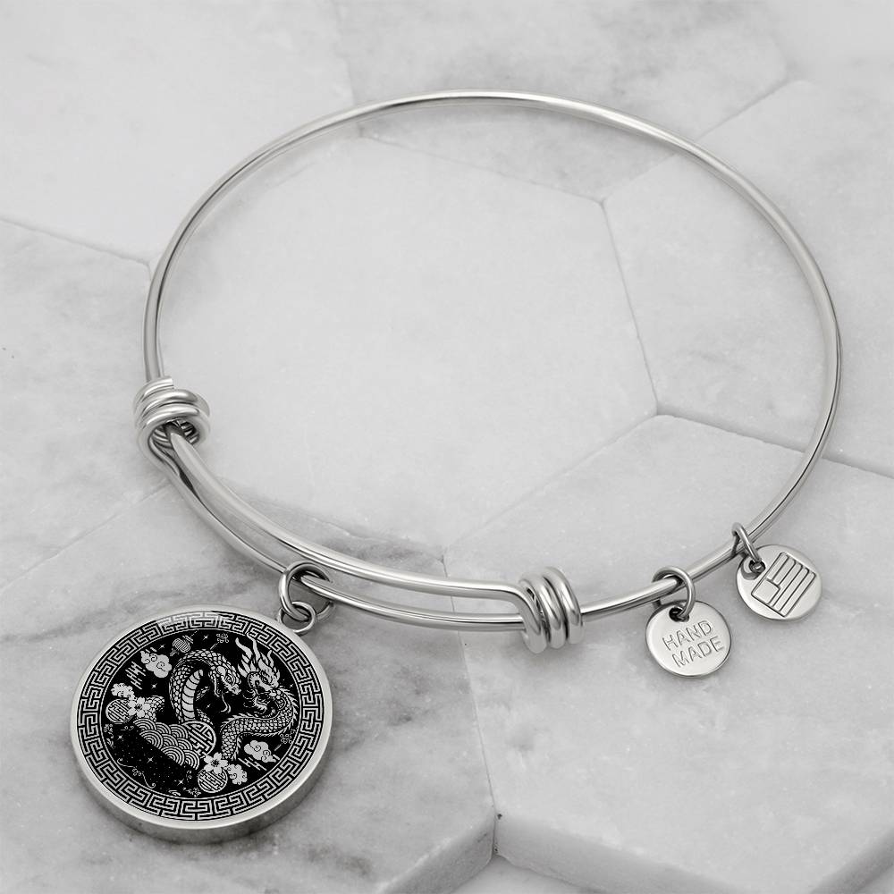 An Elegant silver Year of the Dragon and Snake Bracelet. The colors are silver and black. This bangle bracelet & pendant has an engraving option for a personalization.