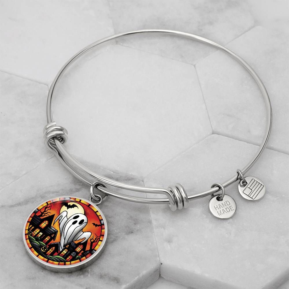 An elegant silver pendant Halloween Ghost Bracelet. The colors are white, black, yellow, orange and green. This jewelry offers personalization with an engraving option for a name.