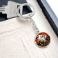 An elegant silver pendant Halloween Ghost Keychain. The colors are white, black, yellow, orange and green. This jewelry offers personalization with an engraving option for a name.