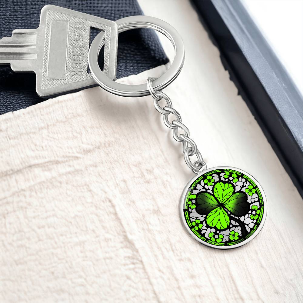 Elegant Silver pendant featuring a vivid Four Leaf Clover Keychain, set against a silver backdrop. This jewelry offers personalization with an engraving option for a name