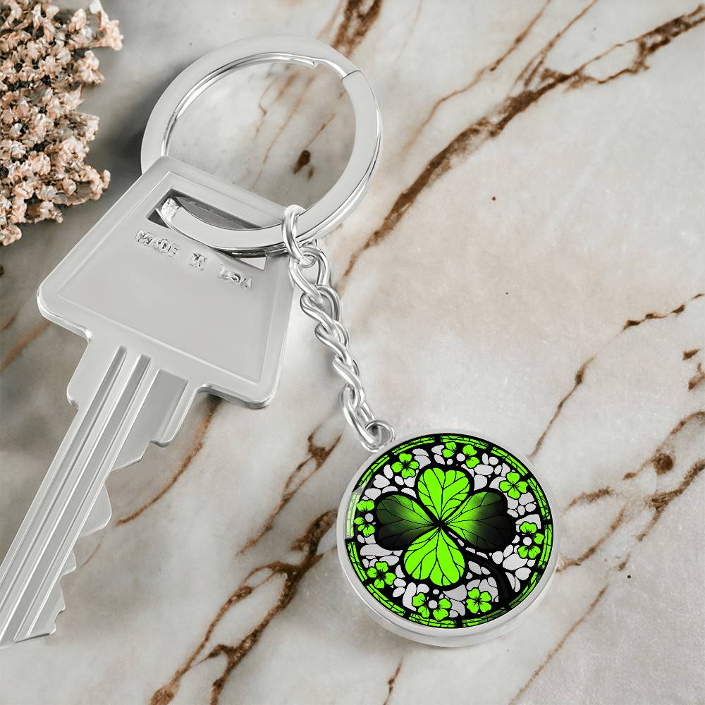 Elegant Silver pendant featuring a vivid Four Leaf Clover Keychain, set against a silver backdrop. This jewelry offers personalization with an engraving option for a name