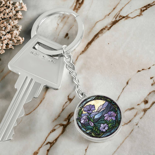 An elegant silver pendant Morning Glory Keychain, The Colors are green, purple, blue and tan. This jewelry offers personalization with an engraving option for a name.