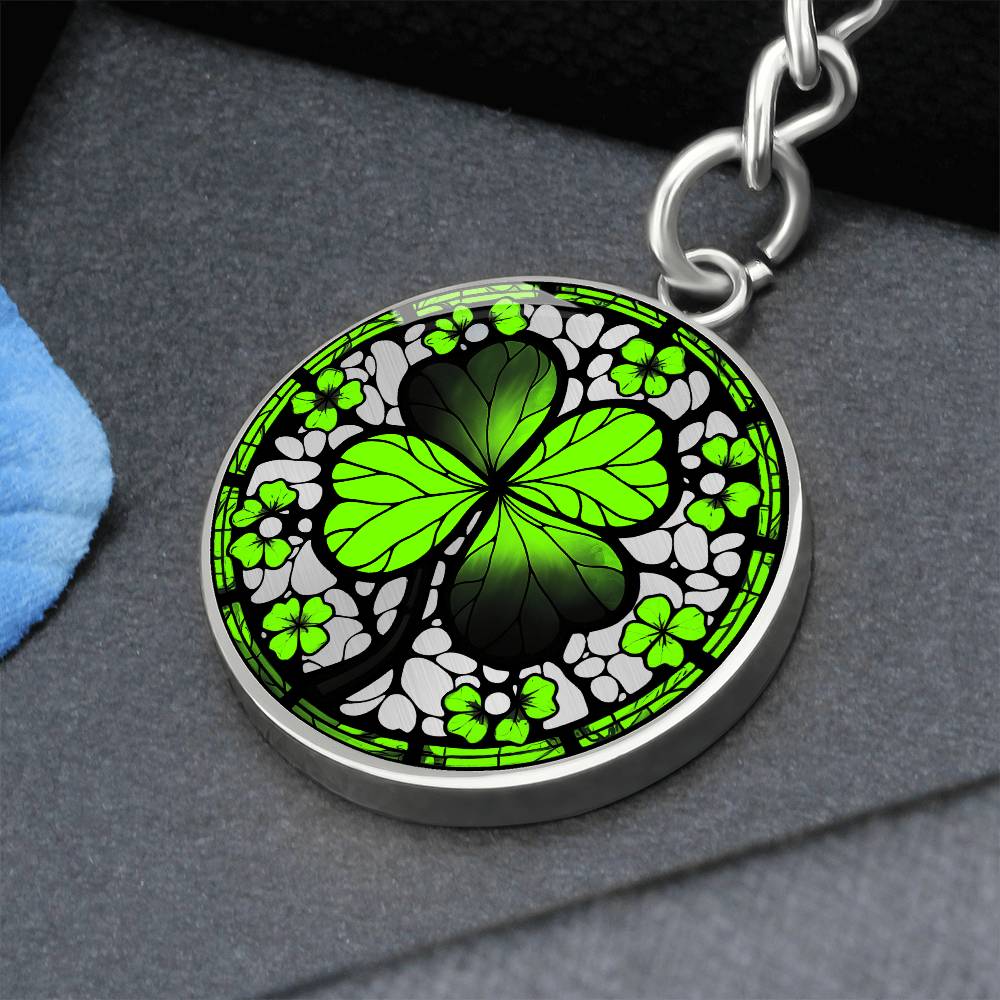 Elegant Silver pendant featuring a vivid Four Leaf Clover Keychain, set against a silver backdrop. This jewelry offers personalization with an engraving option for a name