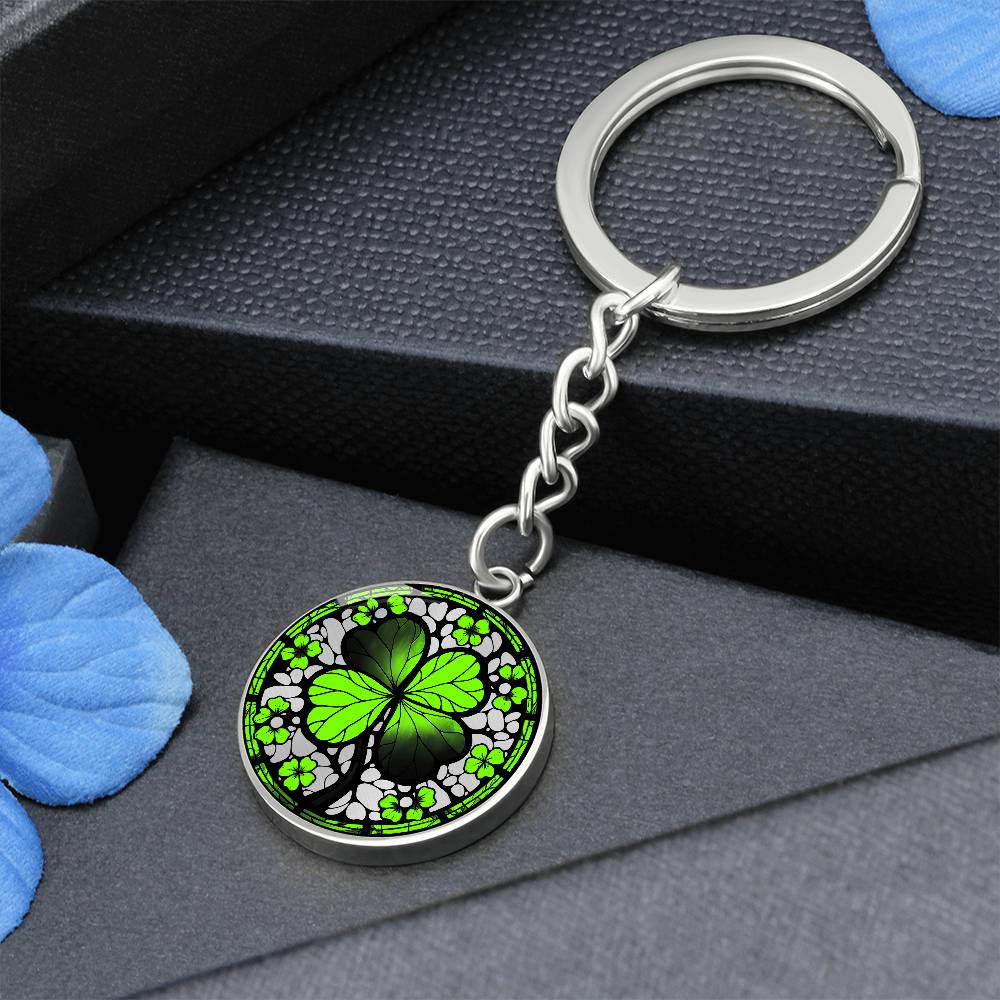 Elegant Silver pendant featuring a vivid Four Leaf Clover Keychain, set against a silver backdrop. This jewelry offers personalization with an engraving option for a name