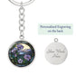 An elegant silver pendant Morning Glory Keychain, The Colors are green, purple, blue and tan. This jewelry offers personalization with an engraving option for a name.