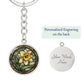 An Elegant Silver pendant Daffodil Necklace, March&#39;s birth month flower. Colors, Yellow flower, Green Grass, Brown Border, Dark Green background. This jewelry offers personalization with an engraving option for a name.