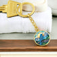 An elegant gold pendant Bluebird Necklace. The colors are blue, green,  brown and yellow. This jewelry offers personalization with an engraving option for a name.
