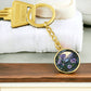 An elegant gold pendant Morning Glory Keychain, The Colors are green, purple, blue and tan. This jewelry offers personalization with an engraving option for a name.