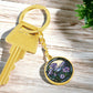An elegant gold pendant Morning Glory Keychain, The Colors are green, purple, blue and tan. This jewelry offers personalization with an engraving option for a name.